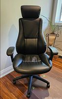 Full front view of black faux leather high-back office chair