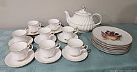 Group view: teapot, 8 cups with saucers, 6 dessert plates