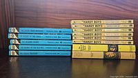 Stacked spines of all Hardy Boys and Nancy Drew volumes showing quantity and formats