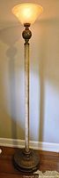 Full view of torchiere lamp illuminated