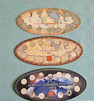 Three oval Canadian Millennium quarter boards stacked: two 1999, one 2000