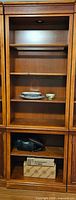 Front view of the single wall unit showing overall structure and shelves