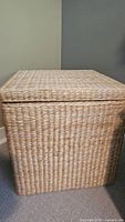 Front view of square wicker hamper with lid on