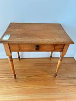 Top-down view showing full table surface, drawer front, turned legs