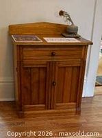 front view of wood wash stand cabinet showing drawer, doors and back splash