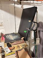 Shelf with Everlite portfolio and mixed books/magazines