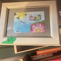 Front view of framed Canadian stamp sheet