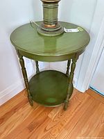full view of green round end table with lamp on top