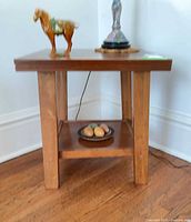 Full view of end table showing overall design and lower shelf