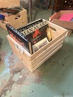 Wooden crate holding the group of books, spines visible