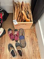 Lot overview: crate with hangers and three pairs footwear
