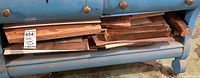 Front view of drawer filled with mixed lumber offcuts