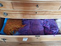 Shawl and skirt folded in drawer showing texture and fringe