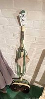 Full view of vintage T. Eaton Co. Viking Standard floor buffer standing upright with cord wrapped around handle