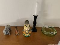 All items grouped: ashtray, candlestick with candle, Ganesha, pig figurine, small animal figurine