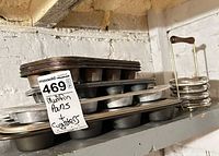 Stack of muffin pans and coaster set on shelf