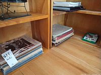 Stacks of sheet music books on shelves with tray of trinkets