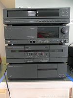 Front view of the Mitsubishi modular sound system stacked, showing all four components including disc player, pre-amplifier, cassette deck, and power amplifier.