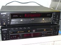Front view of two stacked Sony compact disc recorders, model RCD-W1 on top and RCD-W500C below, showing controls, displays, and CD tray.