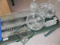 Full set of six crystal serveware pieces on display including platter, bowls, candy bowl, dish and butter dish.