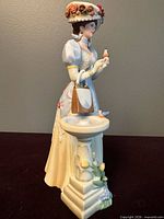 Front left view of Mrs. Albee figurine with birdbath and purse