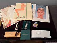 Overview of catalogs, figurines, and boxes on tabletop