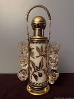 Front view of decanter on stand with six hanging shot glasses