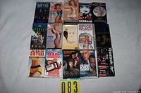 Overall shot of 16 VHS tapes arranged in grid, showing titles and covers