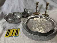 Group shot of all aluminum pieces and brass candlesticks