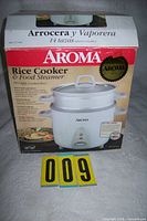 Front of retail box showing Aroma rice cooker and steamer details