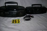 Two Sony boomboxes and Timex clock grouped on white backdrop