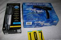 Boxed Conair flat iron and Heat Xtreme hair dryer side by side
