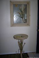 Full view of wall mirror and matching accent table
