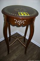 Full view of round mahogany inlaid side table