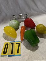 Group shot of six glass fruit/vegetable figurines with pewter candle holder