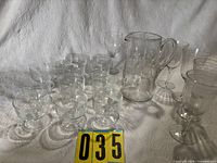 Group view of all dessert coupes, wine glasses, floral pitcher