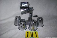 Rotary grater assembled with one drum, four additional drums displayed