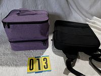 Purple nail polish organizer case beside black laptop backpack