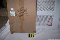 Box of pet stairs next to folded Safety 1st gate
