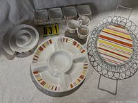 Overview of all Picnic Place serving pieces including divided platter, nested bowls, square bowls set, condiment dish, oval platter with wire rack