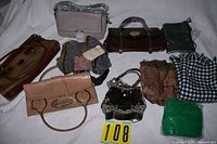Group shot of six handbags and four scarves on white surface