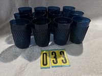Group of twelve blue hobnail rubber tumblers