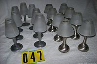 Group of candle lamps showing both base styles and frosted glass shades