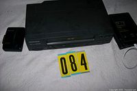 Magnavox VHS player, Sony Walkman, Kindle partially shown