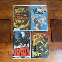 Four comic books laid out on table