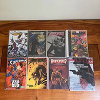 All eight bagged comics laid out on table