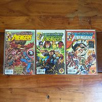 Front view of three Domination Factor: Avengers comic books
