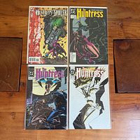 Four bagged Huntress comics laid out