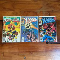 All three bagged and boarded comics laid out
