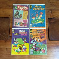 Group shot of four comic books in sleeves
